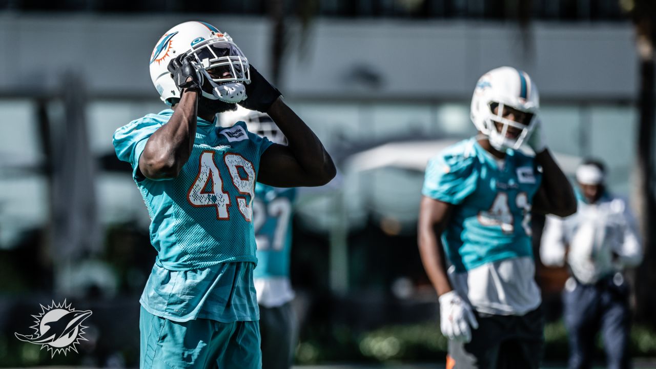 Miami Dolphins linebacker Sam Eguavoen (49) and Miami Dolphins