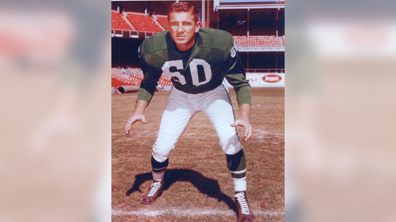 Philadelphia Eagles' Chuck Bednarik looks at an Associated Press photo of  Frank Gifford holding an ice pack to his head in his hospital bed, Nov. 22,  1960 in Philadelphia. Bednarik said he