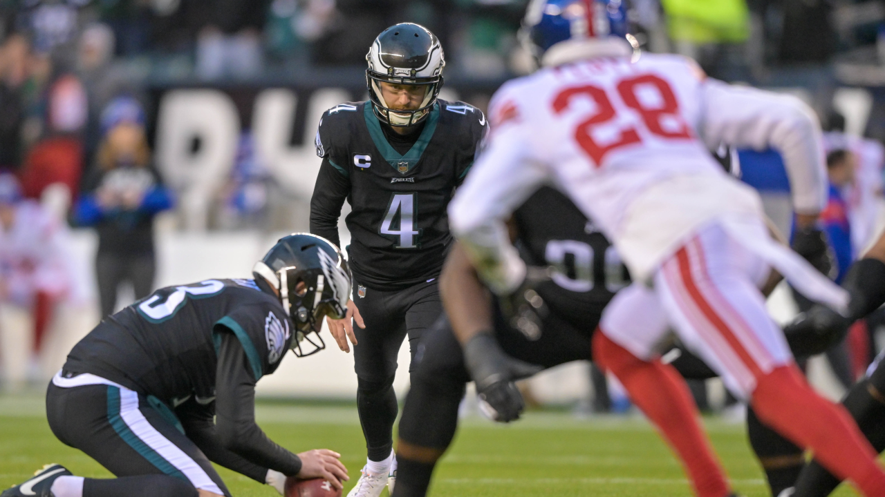 PHILADELPHIA, USA, JANUARY 18, 2023: New York Giants vs. Philadelphia Eagles.  NFL Divisional Round 2023, Silhouette of two NFL American Football Players  against each other. Big screen in background Stock Photo