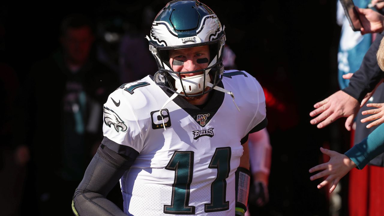 Philadelphia Eagles quarterback Carson Wentz (11) looks at the scoreboard  replay of a fumble his team returned for a touchdown in the fourth quarter  against the Washington Redskins at FedEx Field in