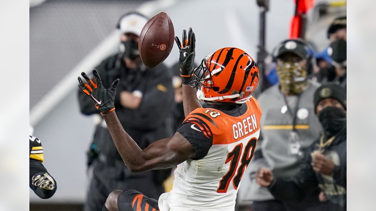 Cincinnati Bengals wide receiver Trent Taylor (11) loses his helmet as he  is tacked by a group of Pittsburgh Steelers during the first half of an NFL  football game, Sunday, Sept. 11