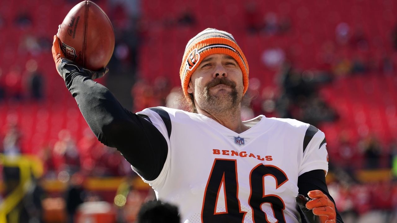 Cincinnati Bengals long snapper Clark Harris tosses a football to