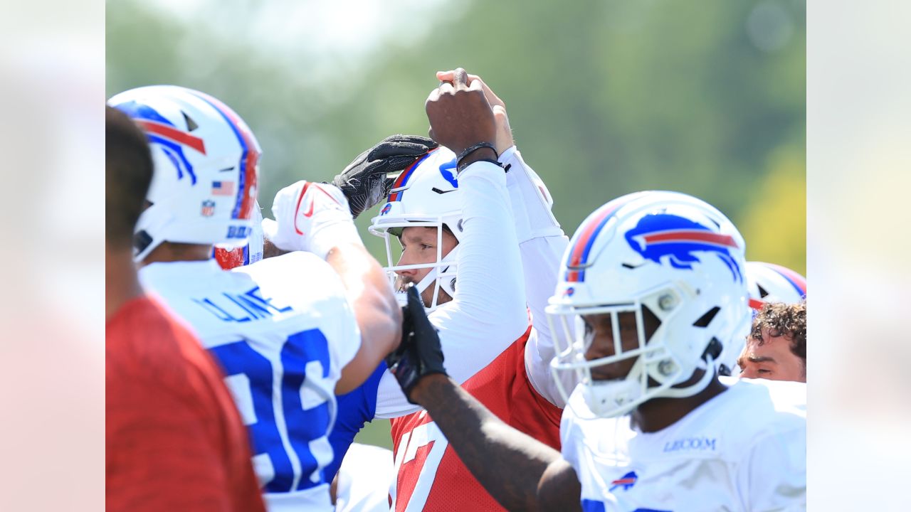 Buffalo Bills' Tre'Davious White sneaks a peak at Baltimore Ravens' play  sheets blown onto field