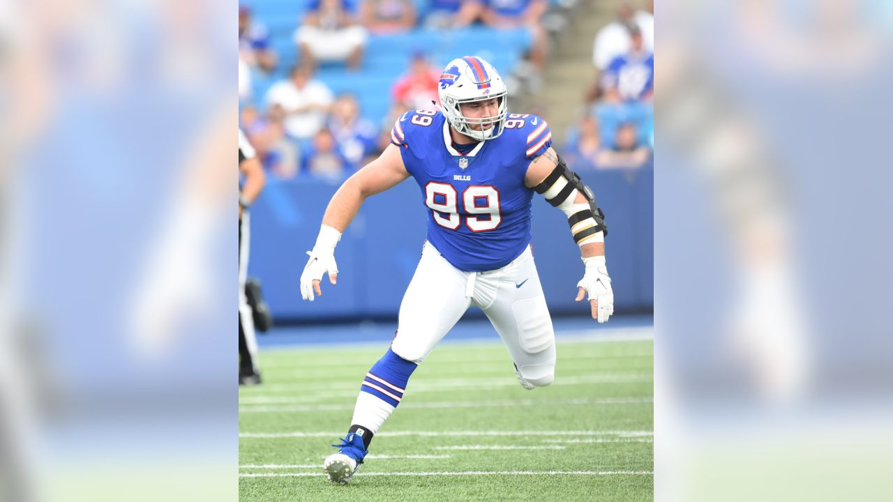 Buffalo Bills' Jerry Hughes gets his helmet stuck on teammate's jersey