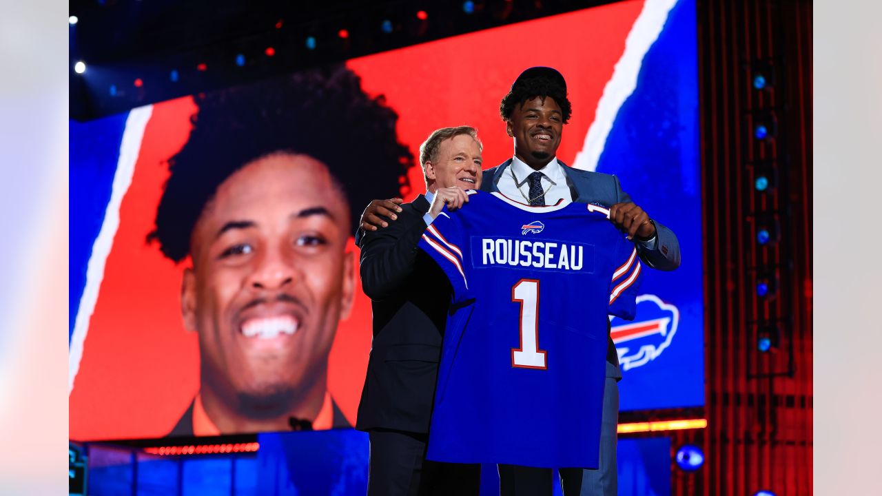 Miami edge rusher Gregory Rousseau, right, holds a team jersey with NFL  Commissioner Roger Goodell after the Buffalo Bills selected Rousseau with  the 30th pick in the first round of the NFL