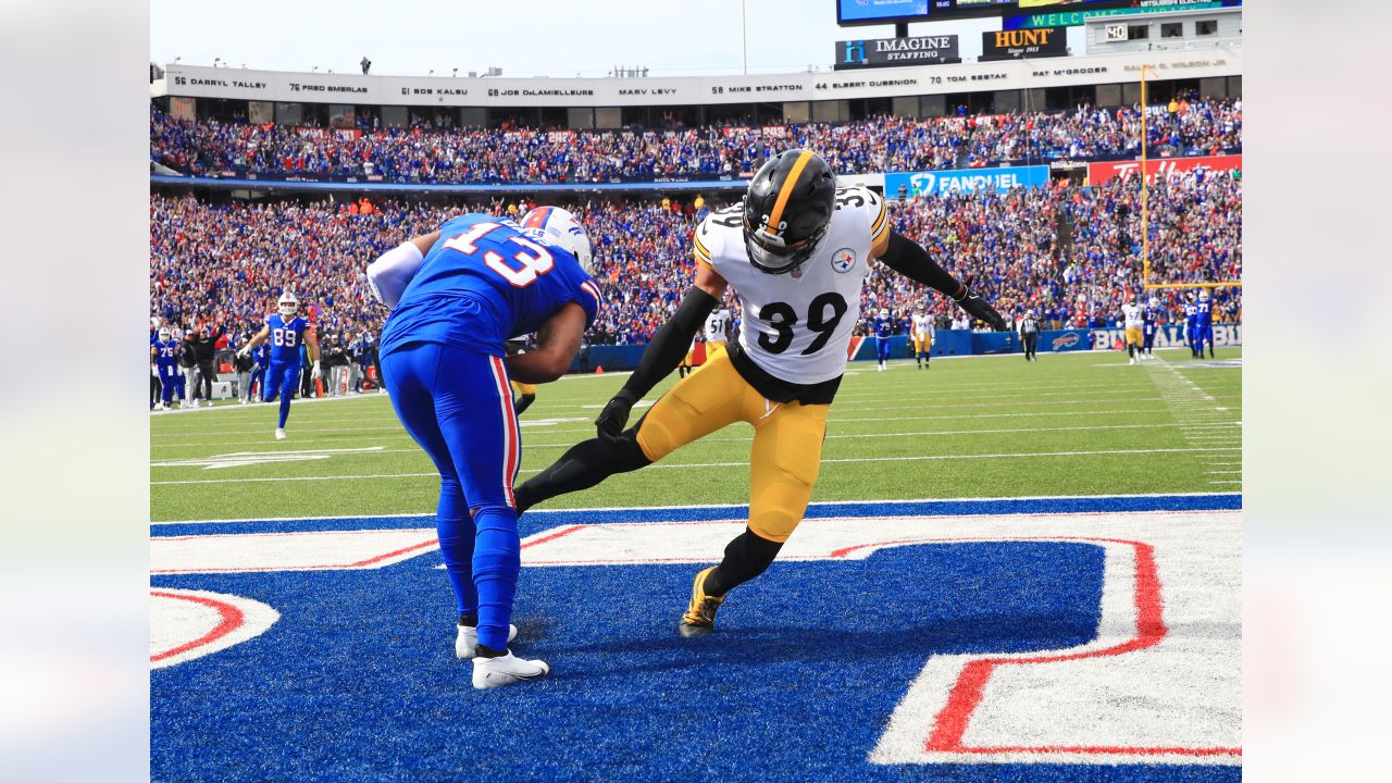 Buffalo Bills quarterback Josh Allen holds a plate with a turkey leg as  cornerback Tre'Davious White (27) leans over to take a bite as they  participate in a post game broadcast interview