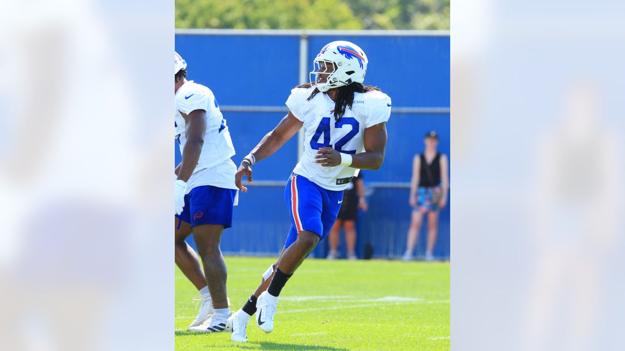 Buffalo Bills' Tre'Davious White sneaks a peak at Baltimore Ravens' play  sheets blown onto field