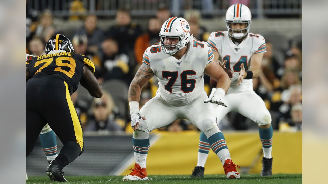 Miami Dolphins center Evan Boehm (76) looks over the defense of