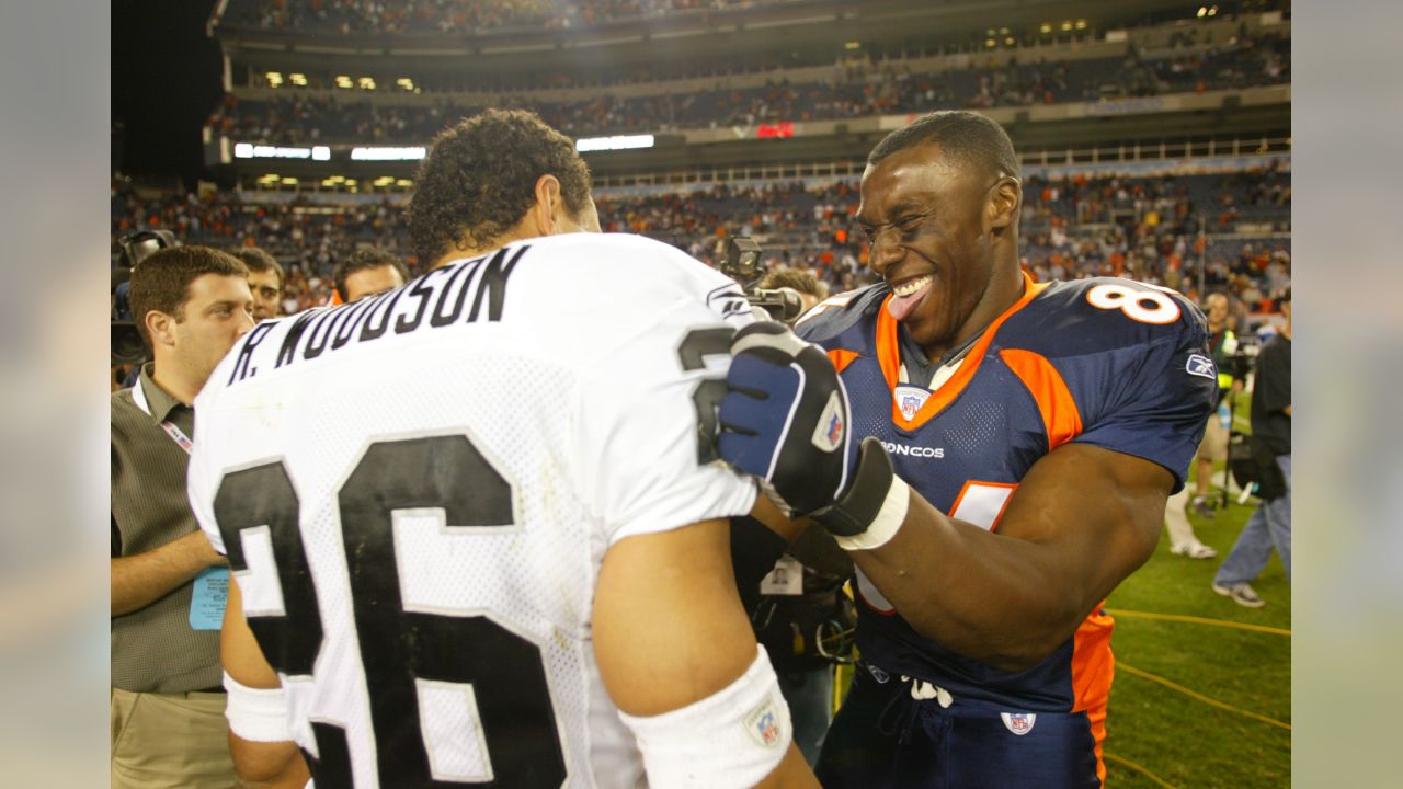 Former Denver Broncos quarterback John Elway, right, congratulates former  tightend Shannon Sharpe as he is inducted into the Denver Broncos Ring of  Fame during ceremonies at half time during the Broncos 