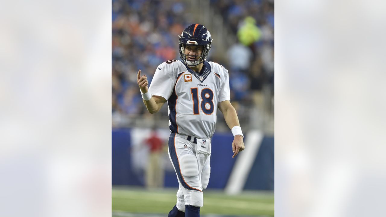 Denver Broncos quarterback Peyton Manning tries to put his jersey back on  his shoulder pads during an NFL football game between the Denver Broncos  and the Kansas City Chiefs, Sunday, Nov. 15