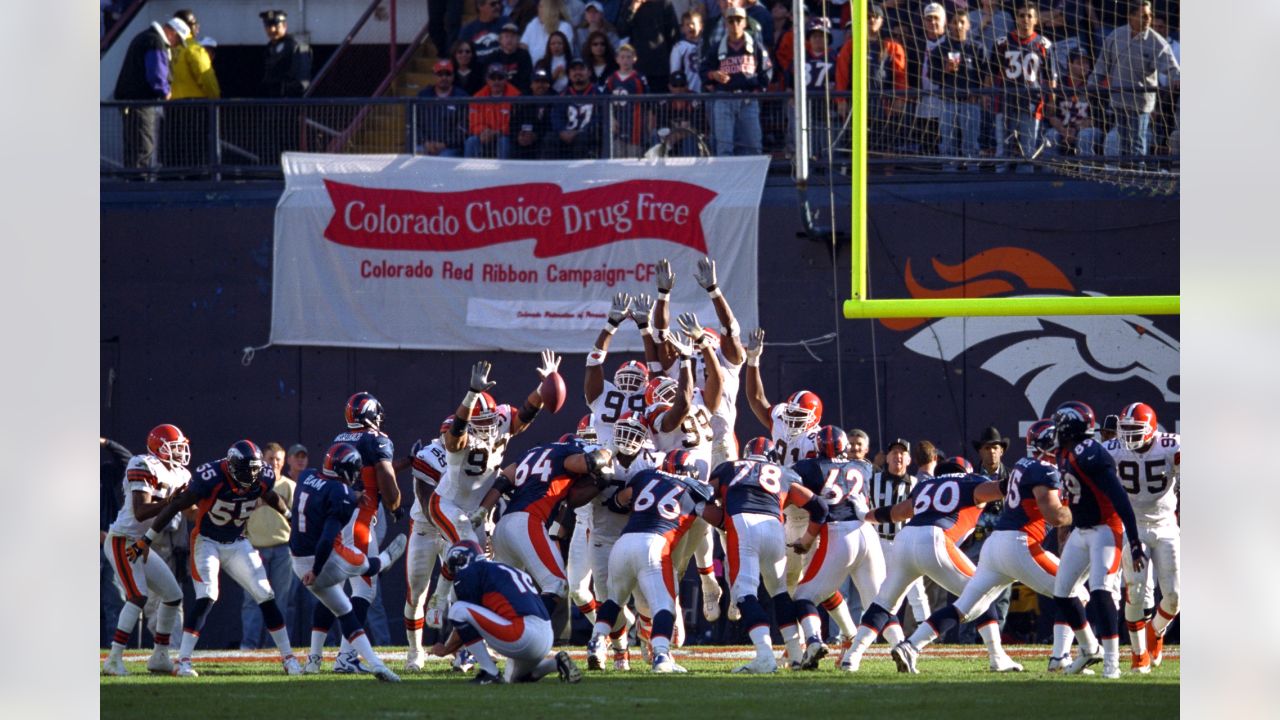 Denver Broncos kicker Jason Elam (1) hops in pain after kicking a