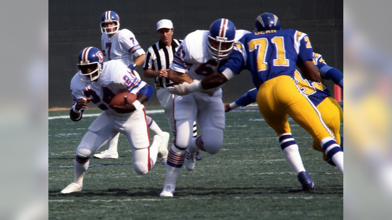 Denver Broncos running back Tatum Bell (R) scores on a three-yard touchdown  run against San Diego Chargers safety Kyle Johnson (L) in the second  quarter at Invesco Field at Mile High in Denver November 19, 2006. (UPI  Photo/Gary C. Caskey Stock