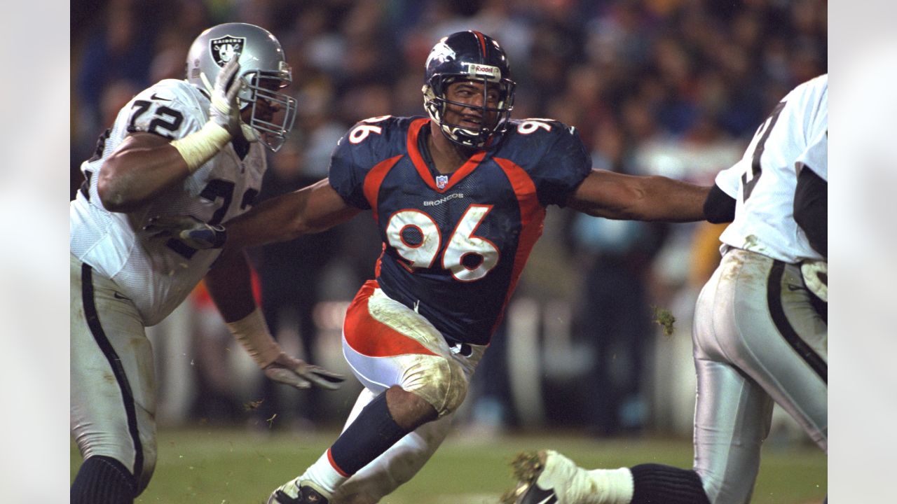 Marcus Allen (32) is tackled by Harald Hasselbach (96) – Denver Broncos  History