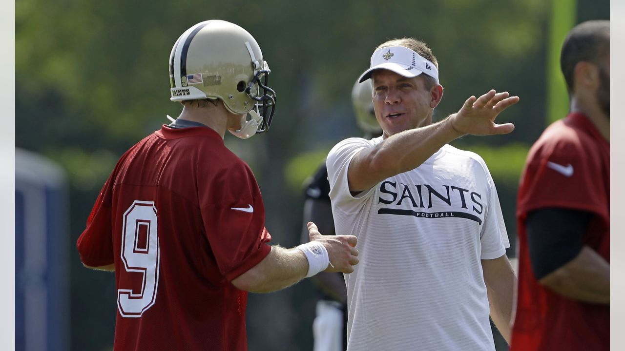 New Orleans Saints and former San Diego quarterback Drew Brees and General  Manager Mickey Loomis, right, hold a Saints jersey presented to Brees  during a news conference at the New Orleans Saints