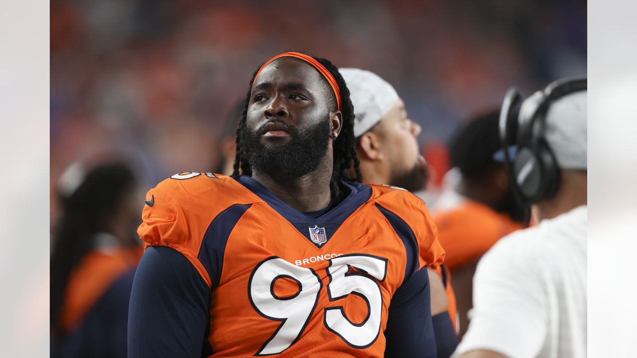 Denver Broncos players run on the field led by McTelvin Agim (95), Marquiss  Spencer (51), Justin Strnad (40), Jamar Johnson (41) with other following  to start an NFL football preseason game against