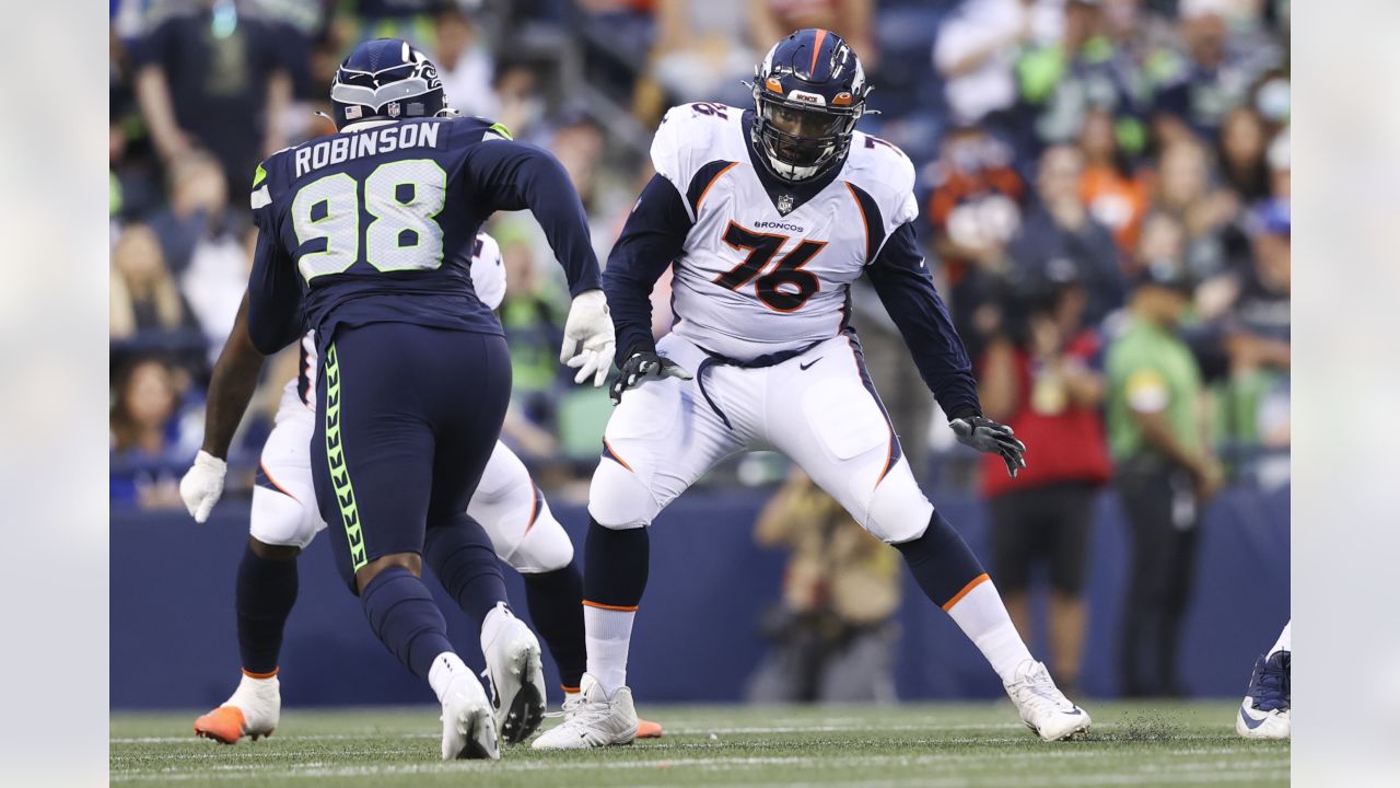 Denver Broncos' Shaun Beyer smiles while on the bench against the Seattle  Seahawks during the second half of an NFL football preseason game,  Saturday, Aug. 21, 2021, in Seattle. The Broncos won