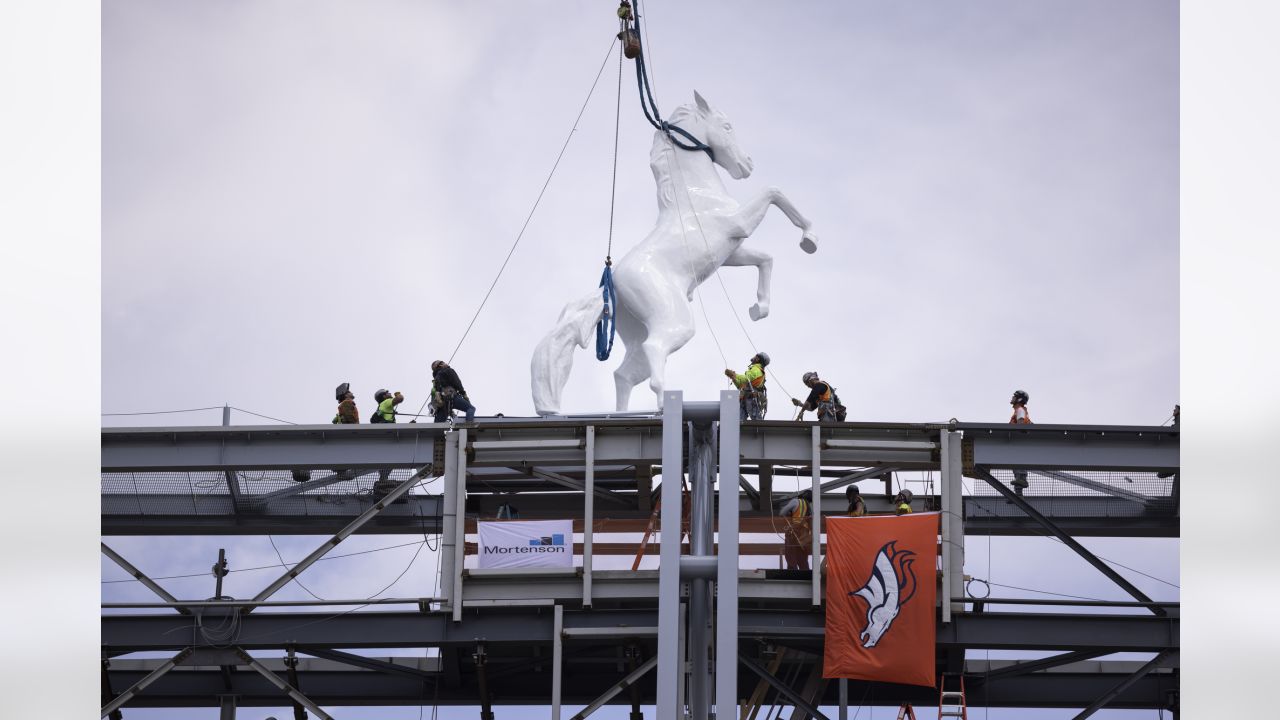 Painting a Broncos Hall of Fame wall at the Empower Field on the