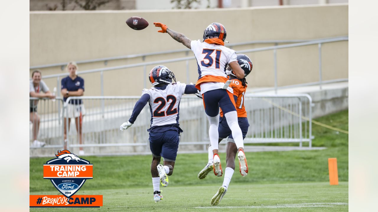 DENVER, CO - OCTOBER 31: Denver Broncos cornerback Pat Surtain II (2) and  free safety Justin Simmons (31) look on as an injured player is tended to  during a game between the