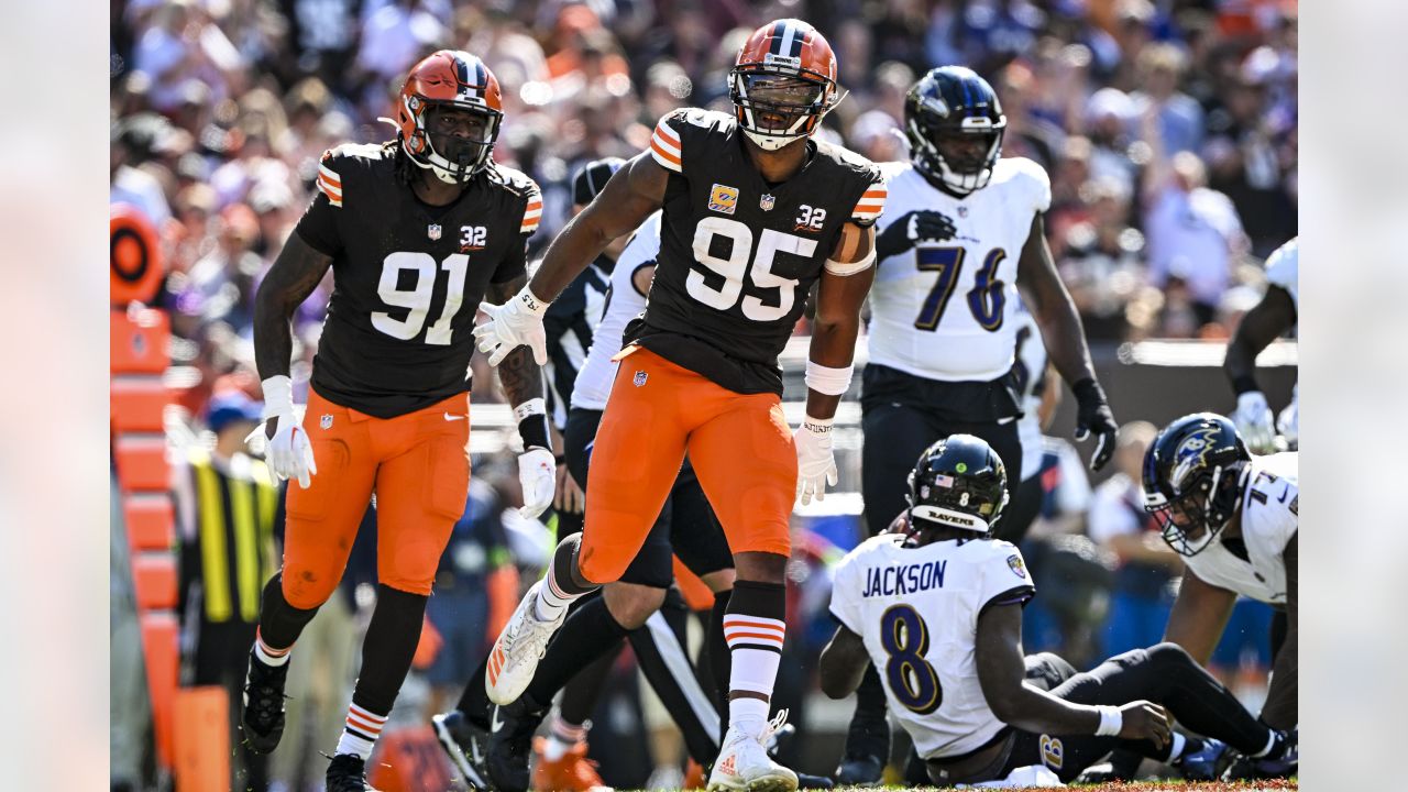 BALTIMORE, MD - OCTOBER 23: Baltimore Ravens quarterback Lamar Jackson (8)  moves to avoid Cleveland Browns defensive end Myles Garrett (95) during the  Cleveland Browns game versus the Baltimore Ravens on October