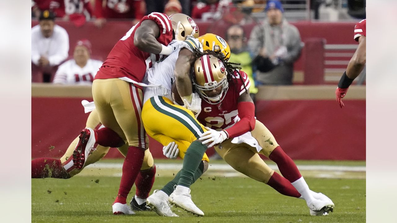 Green Bay Packers running back Aaron Jones (33) runs in front of San  Francisco 49ers cornerback Richard Sherman (25) and strong safety Jaquiski  Tartt (29) during the NFL football NFC Championship game