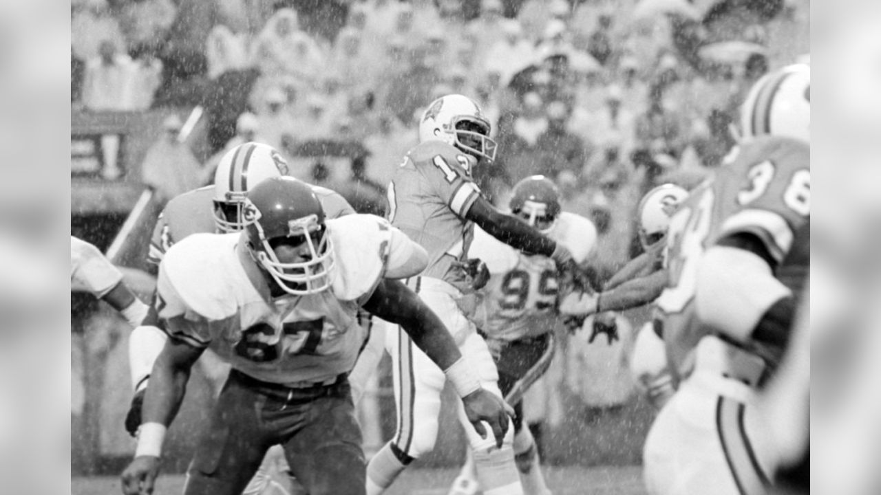 Quarterback Doug Williams (12) of the Tampa Bay Buccaneers eyes a receiver  as left tackle James White (72) of the Minnesota Vikings grabs him during  NFL action in Bloomington, Minn., Nov. 17