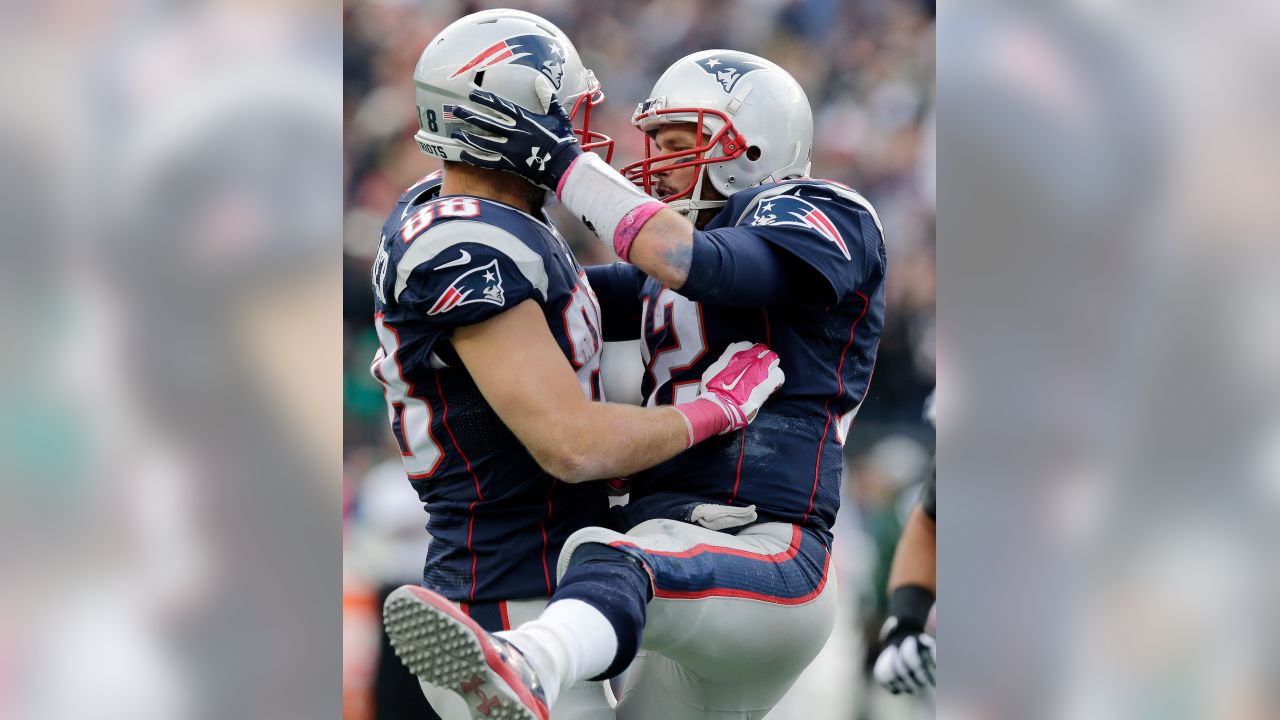 New England Patriots quarterback Tom Brady, top, playfully tackles