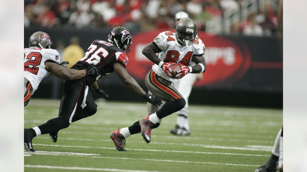 Tampa Bay Buccaneers' wide receiver Joey Galloway (84) is tackled by Atlanta  Falcons' linebacker Keith Brooking (56) during the Bucs 27-0 win in a game  up against the Falcons at Raymond James