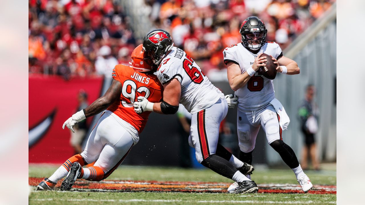 Chicago Bears defensive tackle Justin Jones (93) is held back by Tampa Bay  Buccaneers guard Cody Mauch (69) as Jones tries to stop a pass by Tampa Bay  Buccaneers quarterback Baker Mayfield (