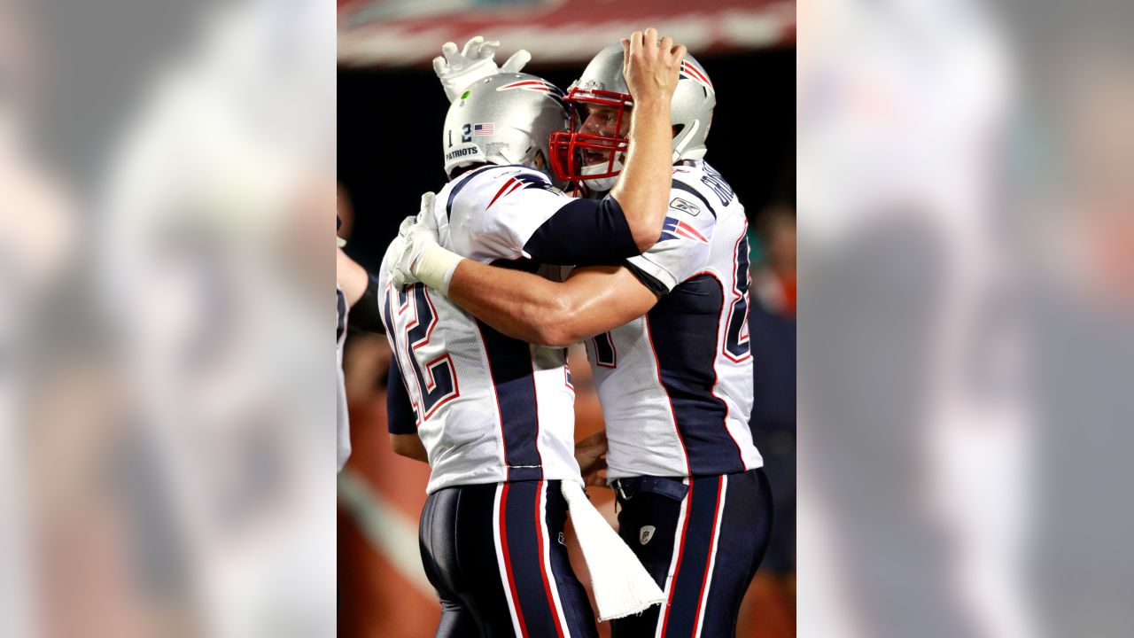 New England Patriots quarterback Tom Brady, top, playfully tackles teammate  Rob Gronkowski after he grabbed and ran with Brady's stolen and recovered  Super Bowl jersey during Boston Red Sox Home Opening Day