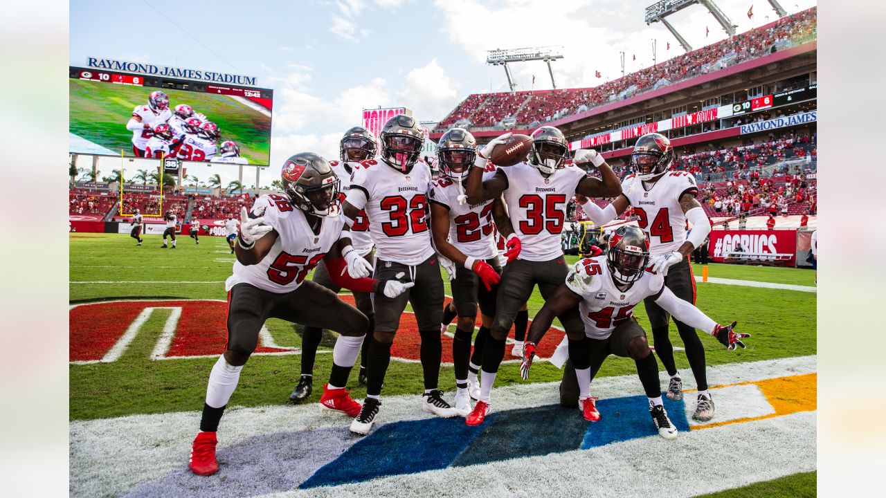 Tampa Bay Buccaneers defensive backs Carlton Davis III (24) smiles as he  walks off the field with his arm around fellow defensive back Jamel Dean  (35) after an NFL football game against