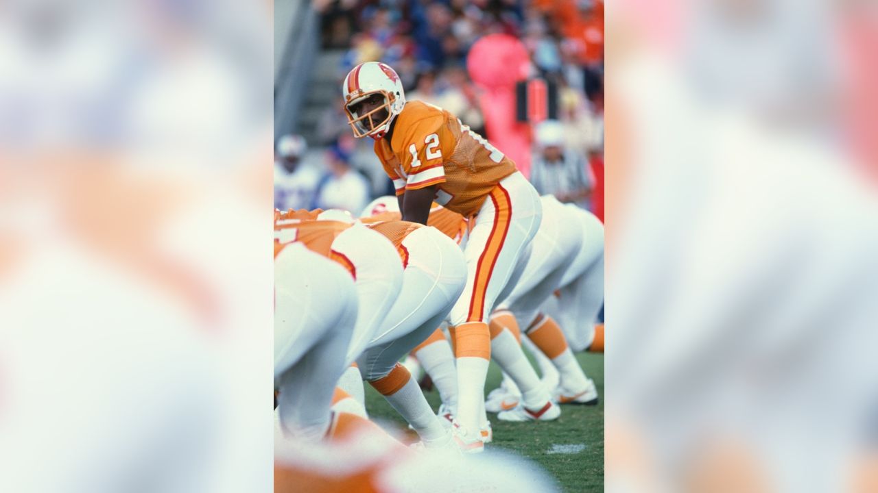 Quarterback Doug Williams (12) of the Tampa Bay Buccaneers eyes a receiver  as left tackle James White (72) of the Minnesota Vikings grabs him during  NFL action in Bloomington, Minn., Nov. 17