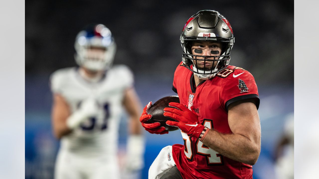 Tampa Bay Buccaneers wide receiver Mike Evans (13) interacts with teammates Tampa  Bay Buccaneers offensive tackle Donovan Smith (76) and Tampa Bay Buccaneers  offensive guard Alex Cappa (65) between plays against the