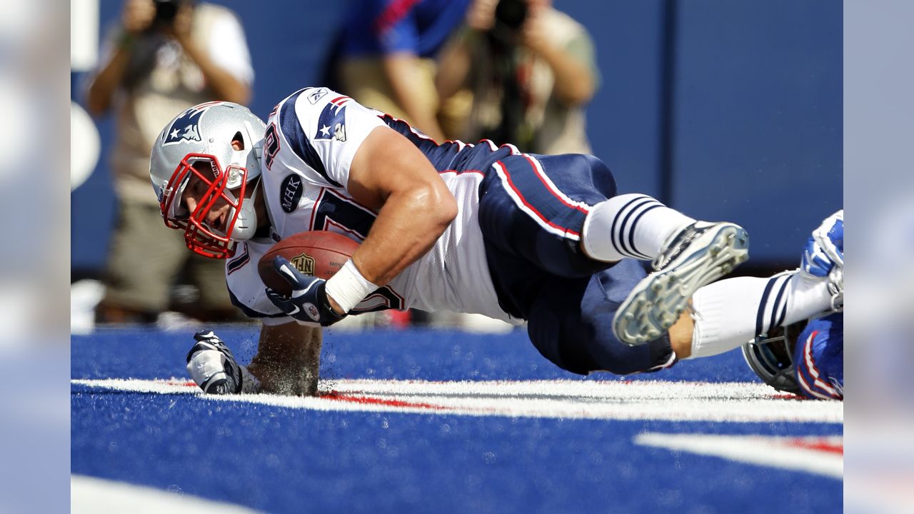 New England Patriots quarterback Tom Brady, top, playfully tackles teammate  Rob Gronkowski after he grabbed and ran with Brady's stolen and recovered  Super Bowl jersey during Boston Red Sox Home Opening Day