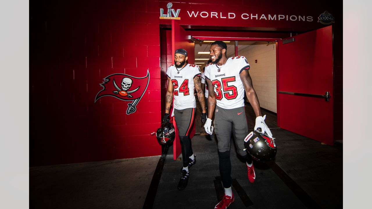 Tampa Bay Buccaneers defensive backs Carlton Davis III (24) smiles as he  walks off the field with his arm around fellow defensive back Jamel Dean  (35) after an NFL football game against