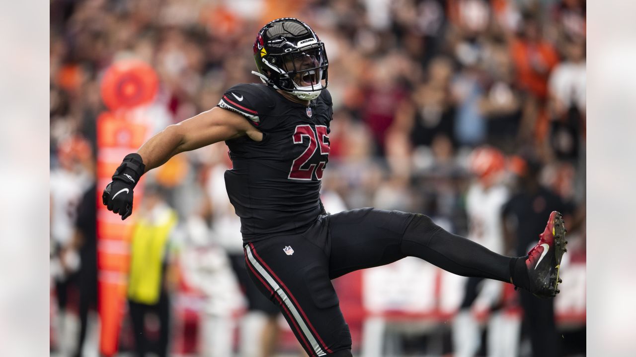 Arizona Cardinals linebacker Myjai Sanders (41) and Cardinals linebacker  Zaven Collins (25) celebrate a defensive stop against the Los Angeles  Chargers during the first half of an NFL football game in Glendale