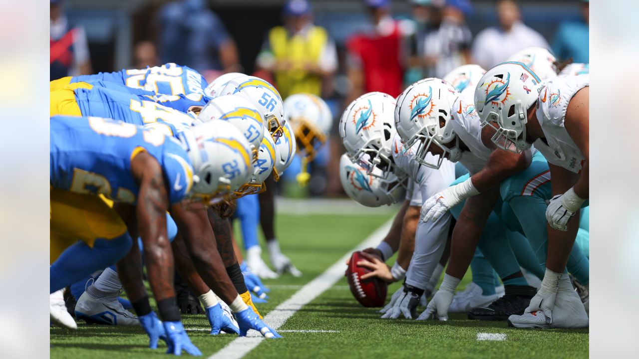 Los Angeles, United States. 10th Sep, 2023. Miami Dolphins quarterback Tua  Tagovailoa (C) runs with the ball fighting off pressure from the Los  Angeles Chargers during an NFL football game. Miami Dolphins