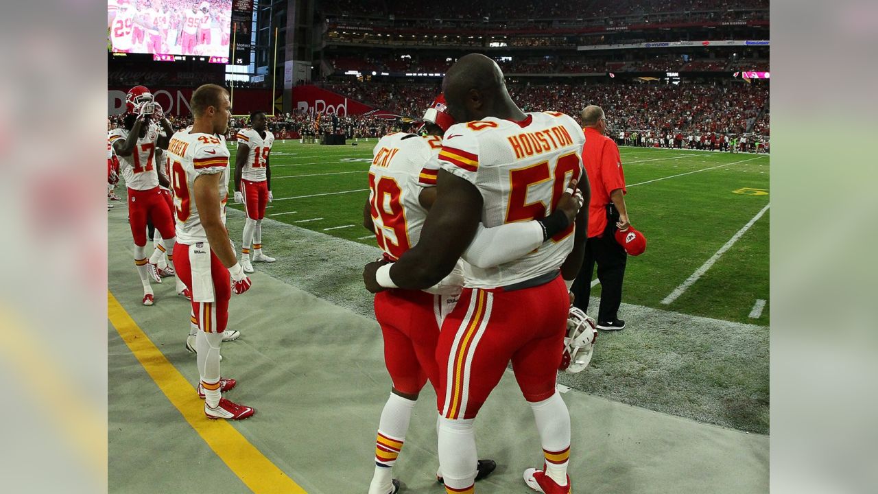 A Kansas City Chiefs fan, dressed in the jersey of Kansas City Chiefs  defensive back Eric Berry (29), stands next to a Oakland Raiders fan during  the first half of an NFL