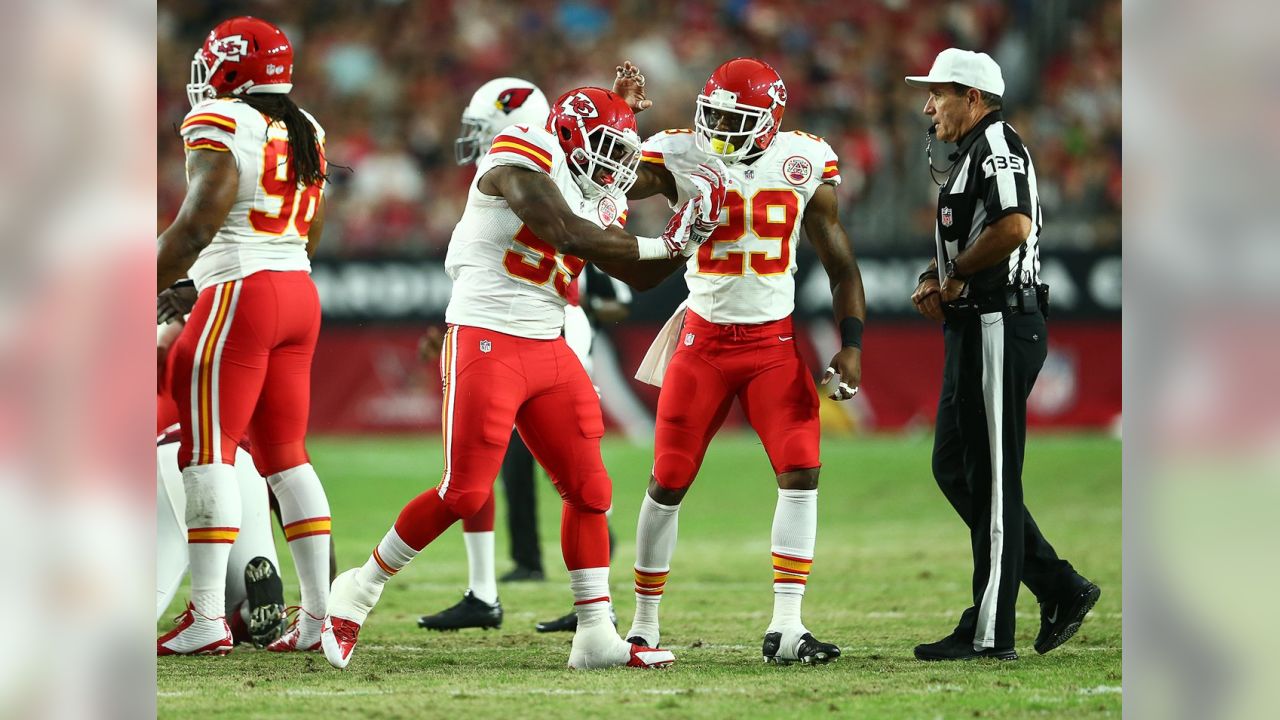 A Kansas City Chiefs fan, dressed in the jersey of Kansas City Chiefs  defensive back Eric Berry (29), stands next to a Oakland Raiders fan during  the first half of an NFL