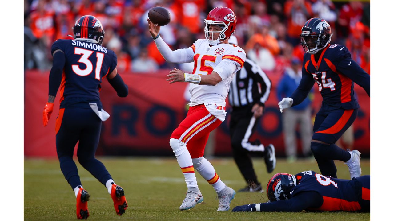 Kansas City Chiefs quarterback Patrick Mahomes (15) makes a no-look touchdown pass during an NFL football game against the Denver Broncos, Sunday, December 11, 2022 in Denver.