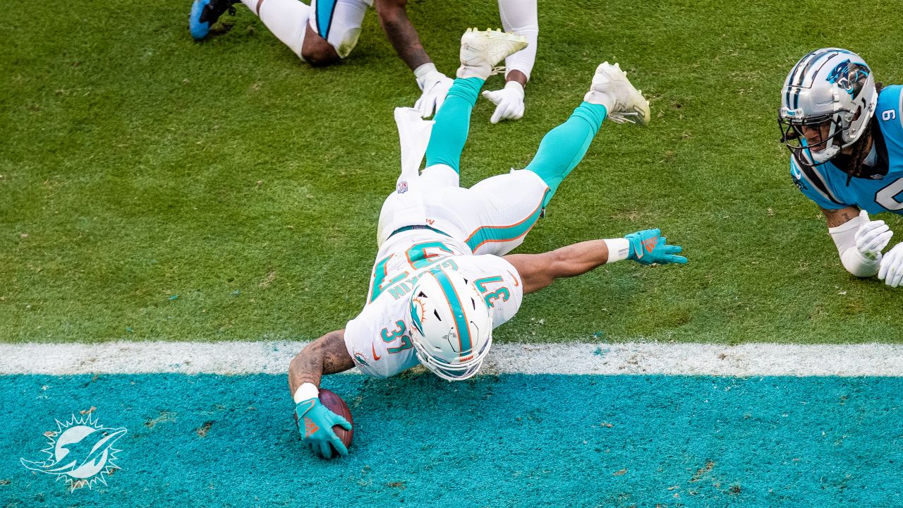 Miami Dolphins running back Myles Gaskin, left, is tackled by New England  Patriots cornerback Joejuan Williams, right, during the second half of an  NFL football game, Sunday, Sept. 12, 2021, in Foxborough