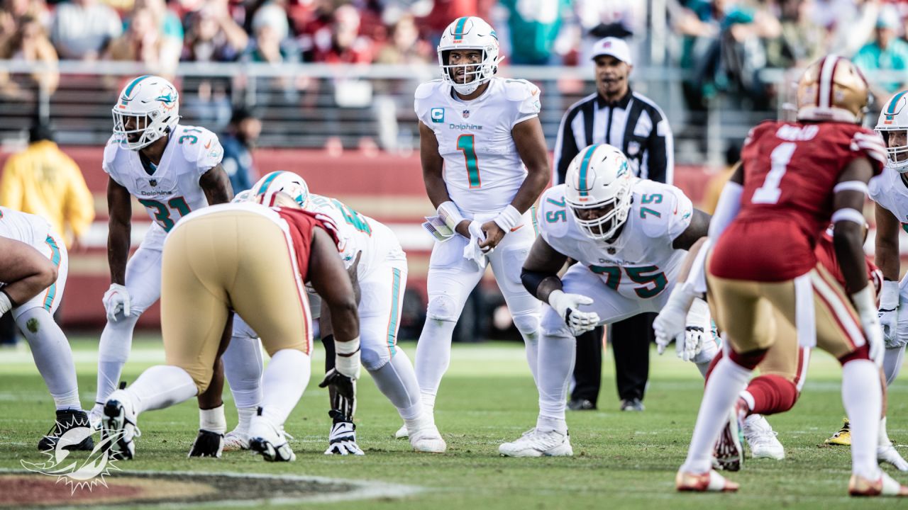 San Francisco 49ers vs. Miami Dolphins. NFL Game. American Football League  match. Silhouette of professional player celebrate touch down. Screen in  background. Stock Photo