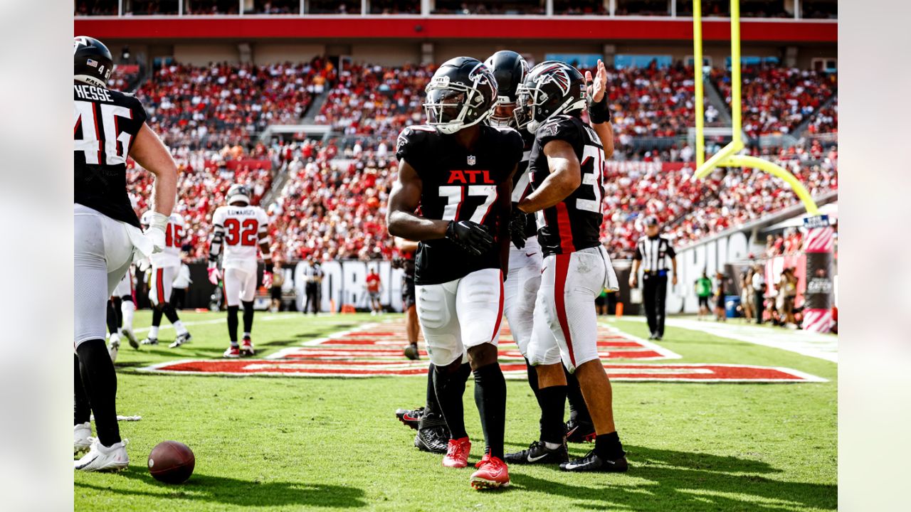 Elisha Jarrett (center), the mother of Atlanta Falcons defensive tackle Grady  Jarrett, gives her son a virtual fist pump outside Mercedes-Benz Stadium as  he arrives to play the Seattle Seahawks in the