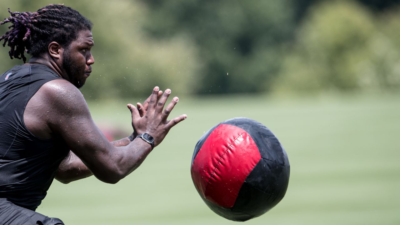 Atlanta Falcons offensive tackle Kaleb McGary (76), left, works against an  unidentifed teammate during the first day of team's NFL football training  camp pratice Wednesday, July 26, 2023, in Flowery Branch, Ga. (