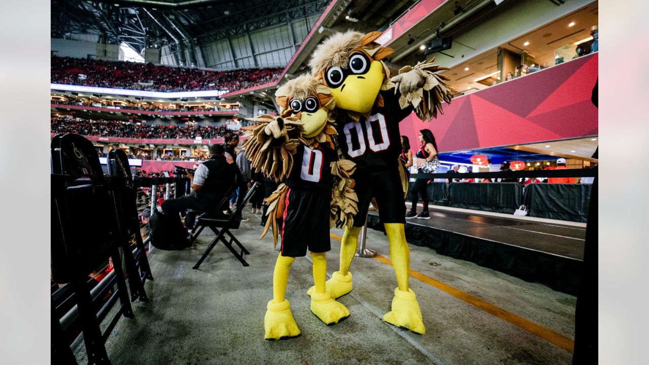 Atlanta Falcons fans pose for photos with team mascot Freddie the