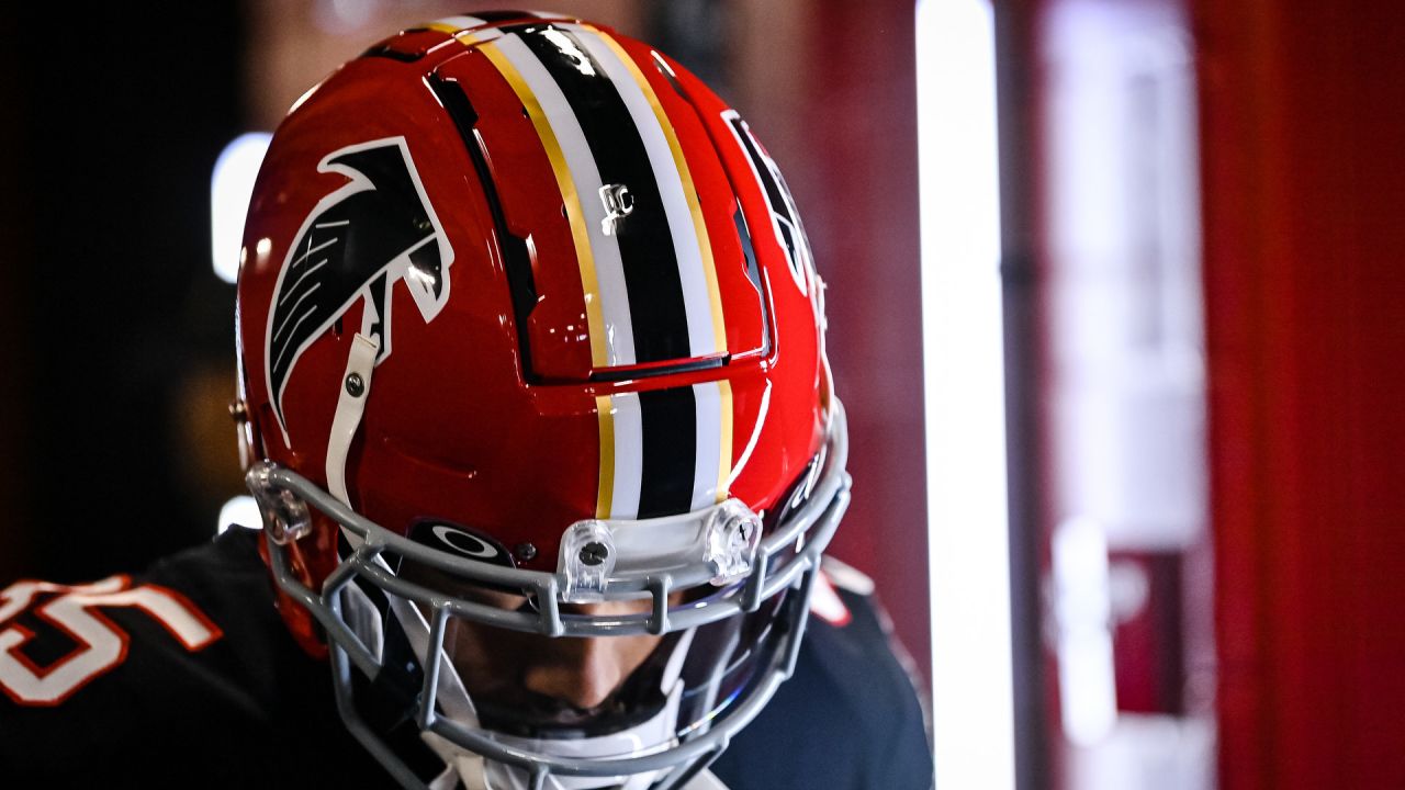 An old Atlanta Falcons helmet is raised by a fan during the first half of  an NFL football game between the Atlanta Falcons and the Philadelphia  Eagles, Sunday, Sept. 12, 2021, in