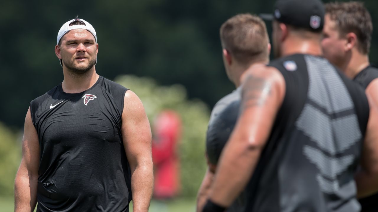 Atlanta Falcons offensive tackle Kaleb McGary (76), left, works against an  unidentifed teammate during the first day of team's NFL football training  camp pratice Wednesday, July 26, 2023, in Flowery Branch, Ga. (