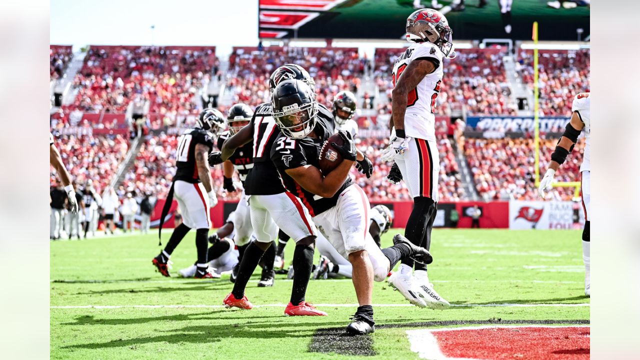 Elisha Jarrett (center), the mother of Atlanta Falcons defensive tackle Grady  Jarrett, gives her son a virtual fist pump outside Mercedes-Benz Stadium as  he arrives to play the Seattle Seahawks in the