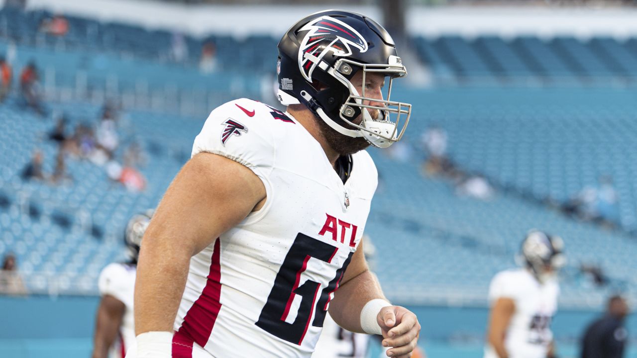 Atlanta Falcons quarterback Taylor Heinicke (4) high fives Atlanta Falcons  offensive lineman Ryan Neuzil (64) as they practice on the field before an  NFL pre-season football game against the Miami Dolphins, Friday