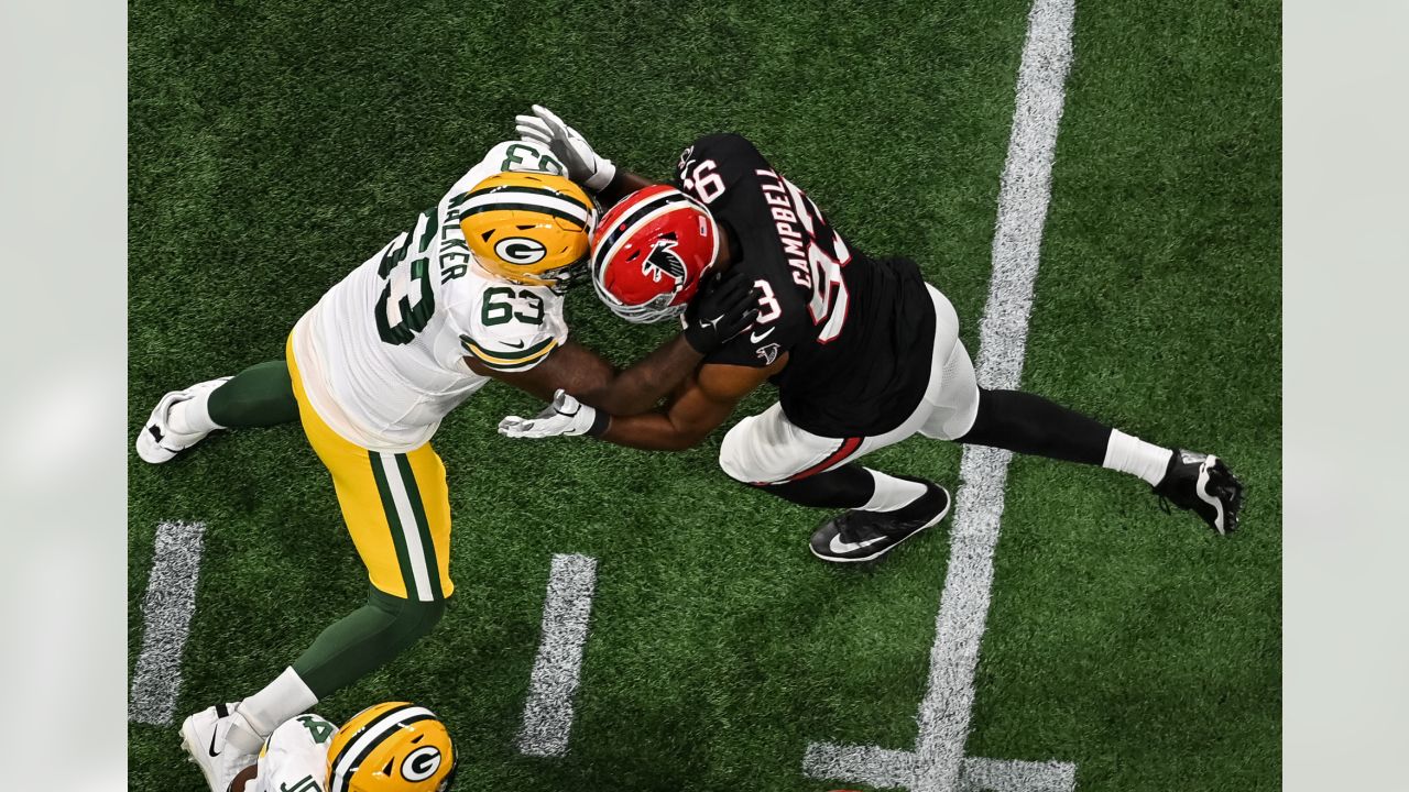 Green Bay Packers quarterback Jordan Love (10) runs down field agaimst  Atlanta Falcons defensive tackle Calais Campbell (93) during the first half  of an NFL football game, Sunday, Sept. 17, 2023, in