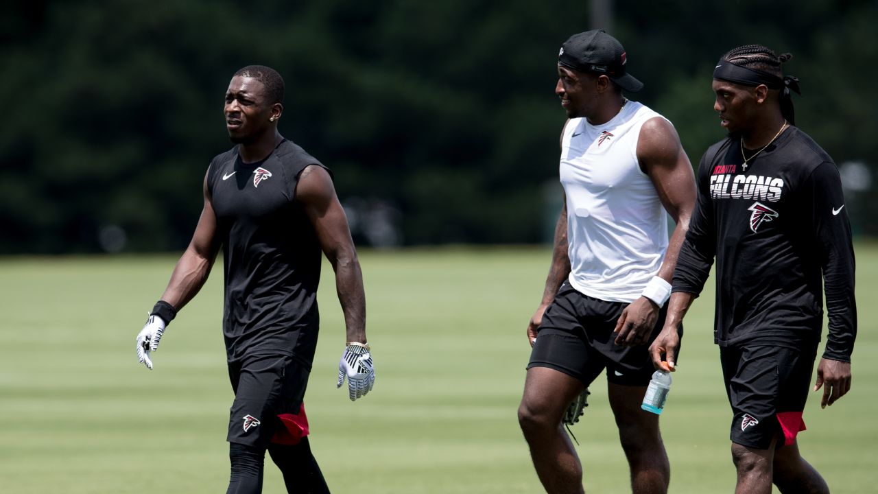 Atlanta Falcons offensive tackle Kaleb McGary (76), left, works against an  unidentifed teammate during the first day of team's NFL football training  camp pratice Wednesday, July 26, 2023, in Flowery Branch, Ga. (